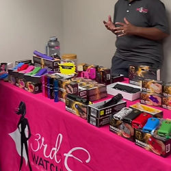 Woman demonstrates pepper spray, stun guns, and personal alarms.