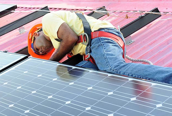 Solar panel engineer on roof installing PVC solar panels
