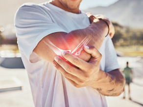 Tennis player holding their elbow. 