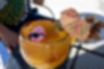 Margarita with a mini pig wearing sunglasses and a cocktail umbrella