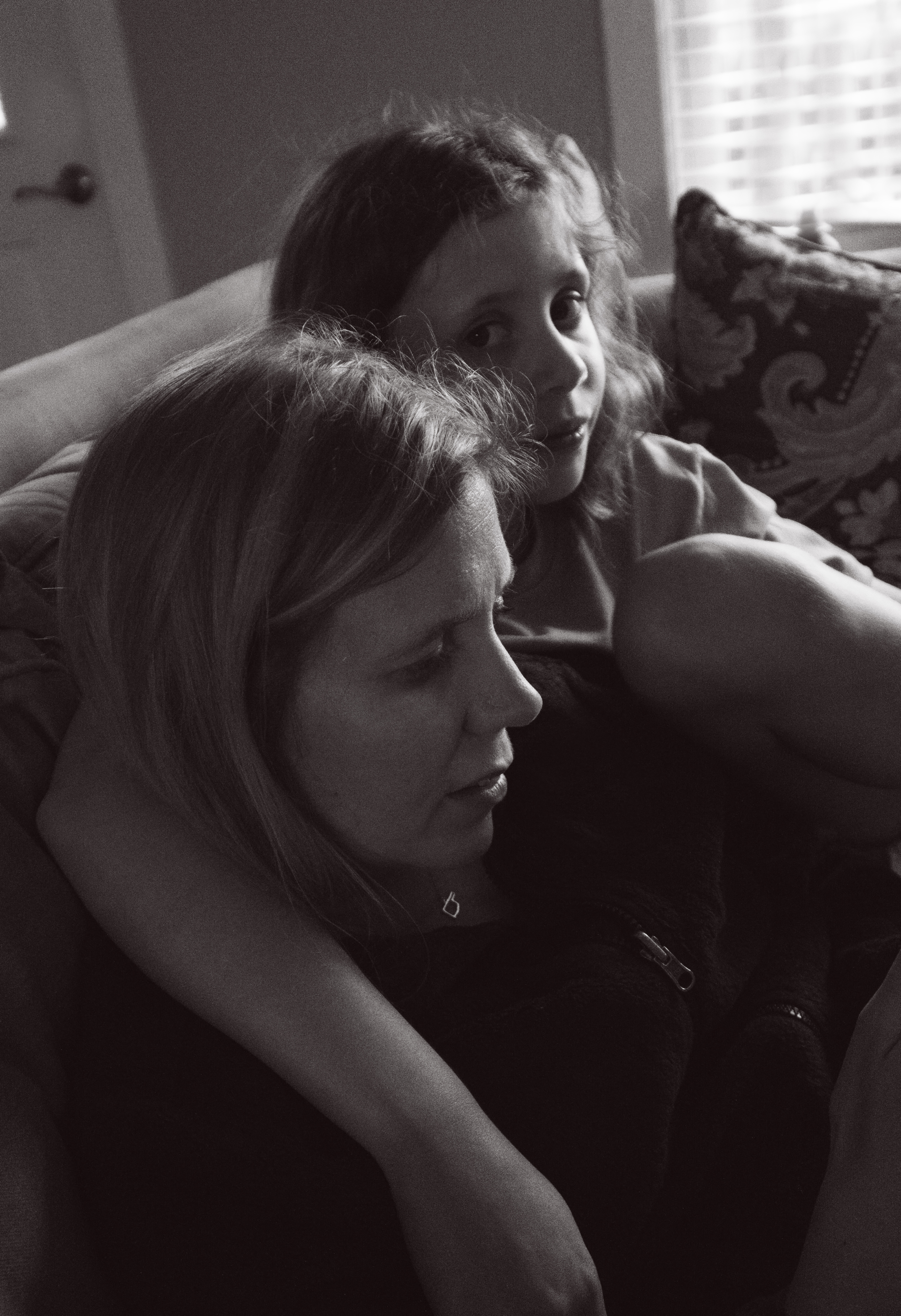 Girls cuddling on couch