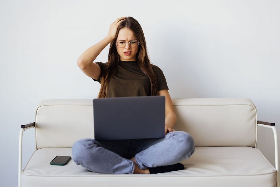Frustrated sad woman feeling tired worried about problem sitting on sofa with laptop, stressed depressed girl troubled with reading bad news online