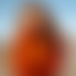 A woman in orange knitwear, autumn feel.