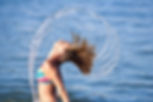 Stock Photo - Motion freeze on a girl splashing the sea water with her hair