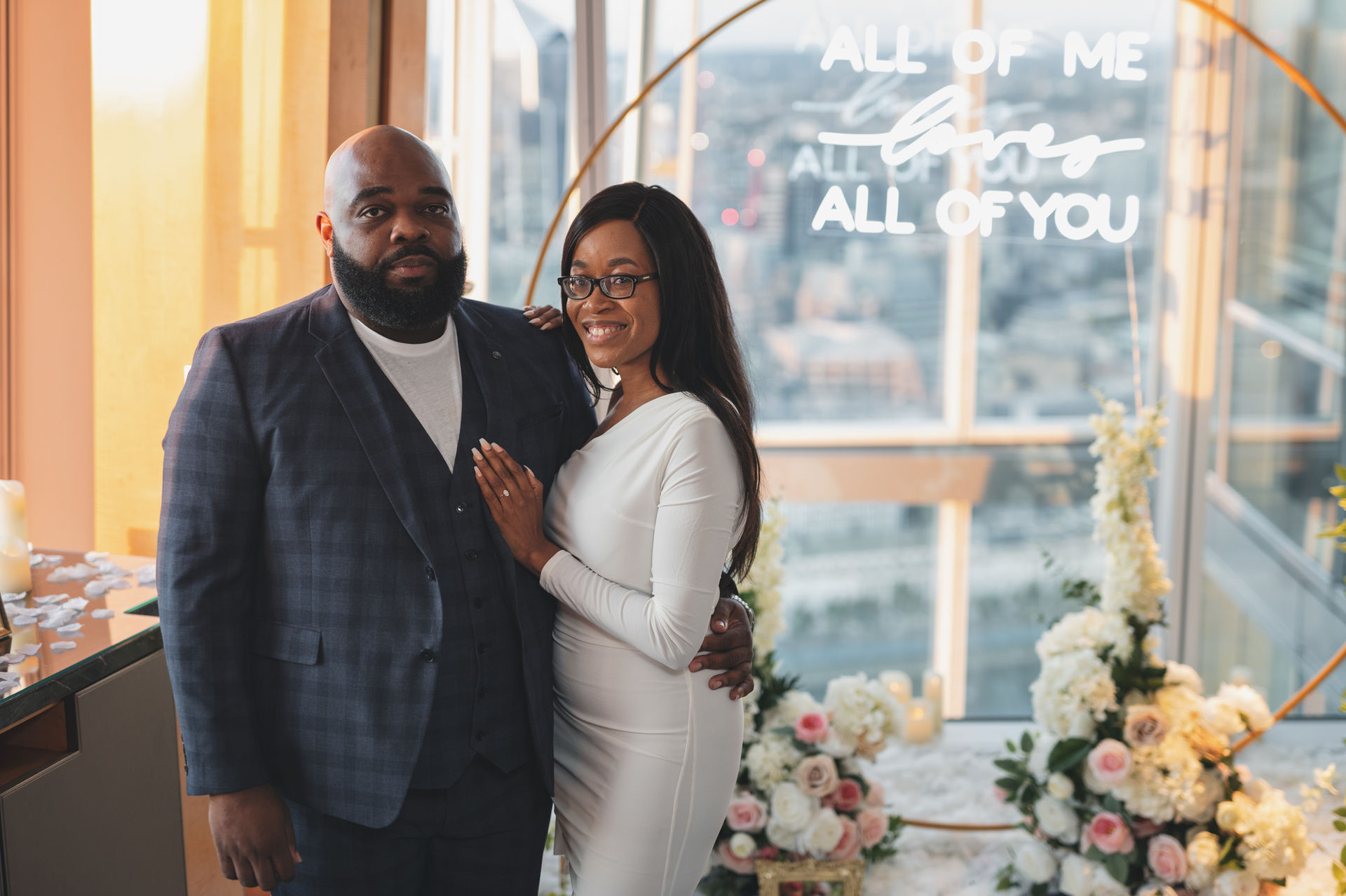 Couple embraces with white dress and