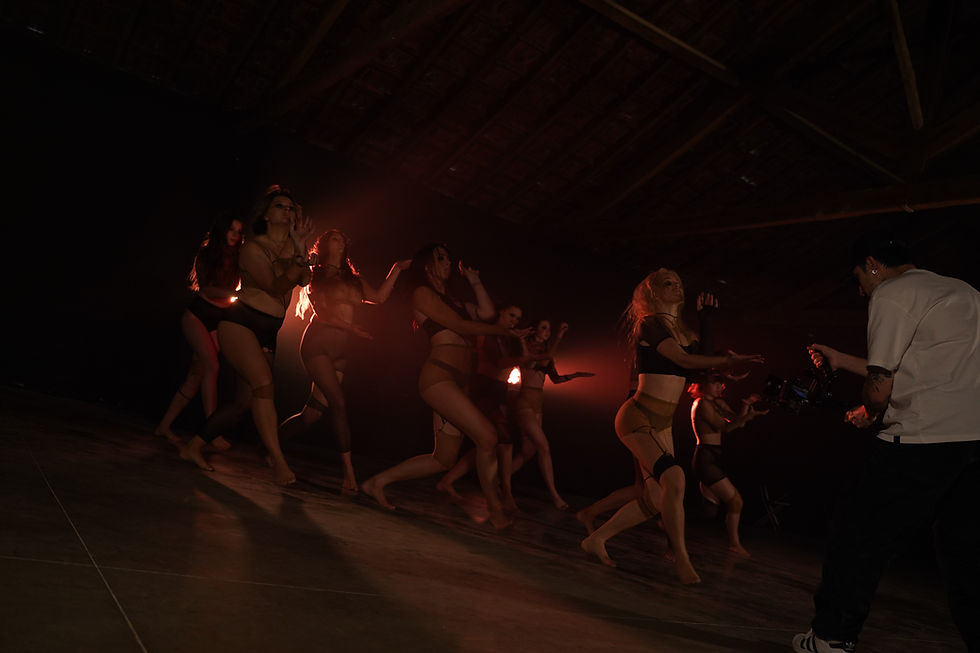 Dancers performing at a training session in a dark studio