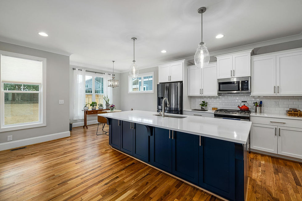 Modern kitchen with navy blue island and white countertops