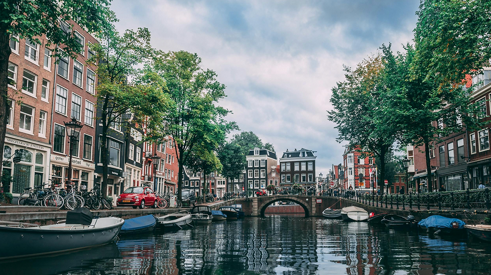 Picturesque canal in Amsterdam with boats and historic buildings