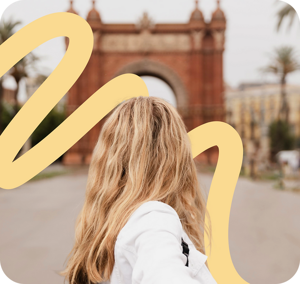 Blonde woman holding hand in front of Arc de Triomf in Barcelona, Spain.