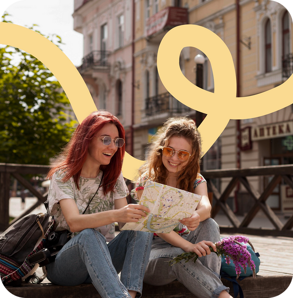 Two women looking at a map, smiling outdoors, sightseeing in Europe.