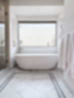 Modern bathroom with a bathtub, towels, and a large window. Legourmet Kitchen