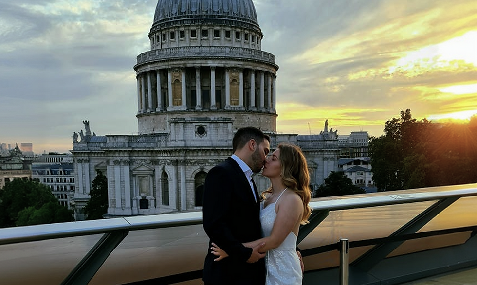 Couple kissing in front of St. Paul's Cathedral at sunset
