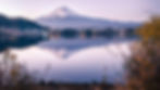 Snow-capped Mount Fuji, Japan, reflecting in a serene lake at twilight.
