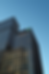 Modern dark skyscrapers, one displaying the green TD logo, against blue sky.