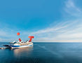 Cruise ship sailing on open sea with blue sky and TUI Petergoordtravel.