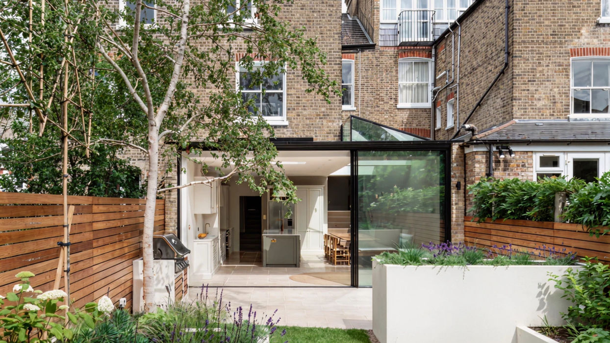 Modern glass rear house extension in London with garden