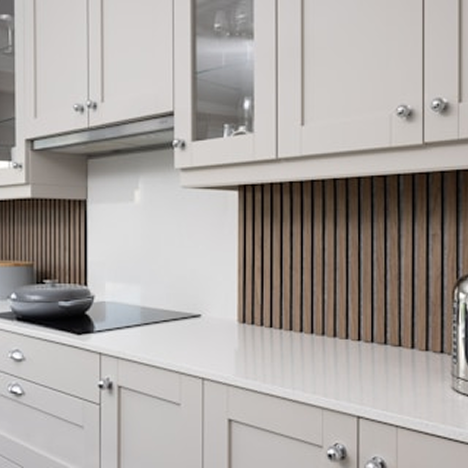 Modern kitchen with wood slat backsplash and light grey cabinets