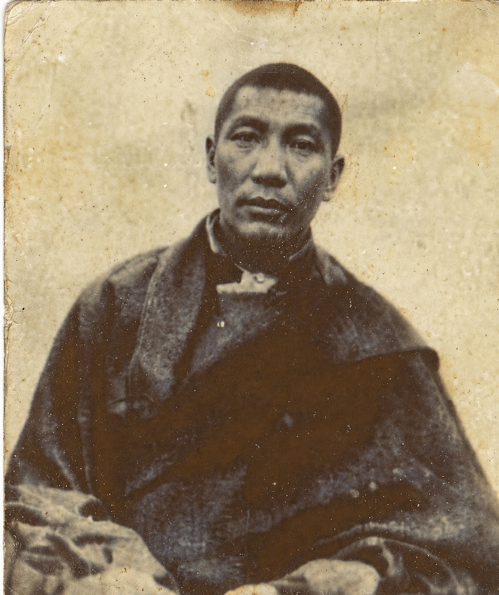 Black-and-white historical portrait of Khenpo Shenga, seated and wearing traditional Tibetan monastic robes, with a calm, serious expression.