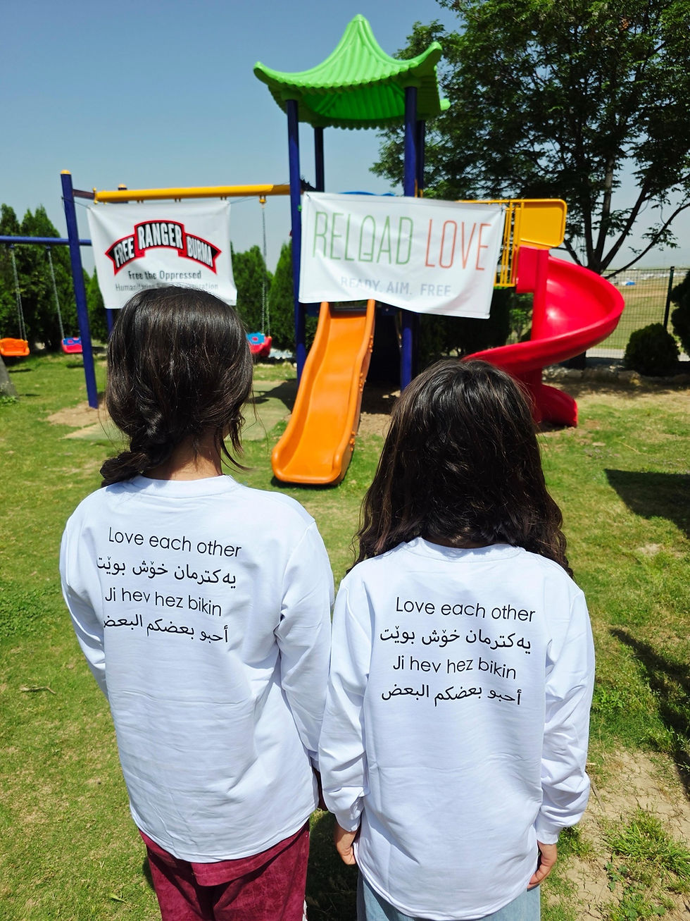 Children in front of a newly constructed playground, made possible by Reload Love and Free Burma Rangers.