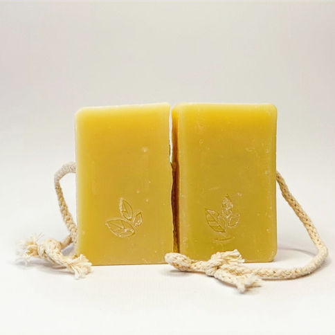 Two yellow soap bars with leaf logo