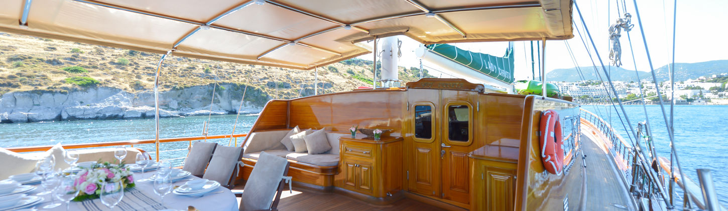 Lady Christa gulet aft deck shaded dining table on teak deck overlooking water
