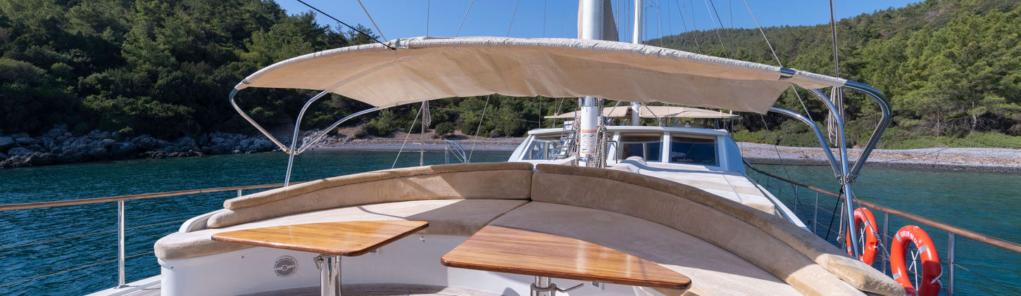 Queen of Sea gulet bow seating area with sea horizon at sunset