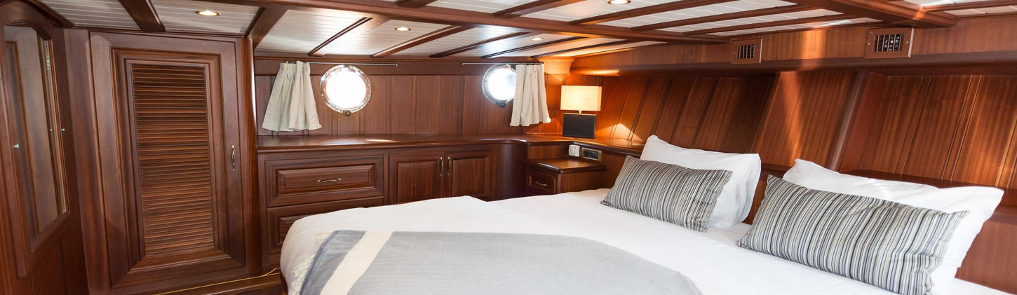 Primadonna gulet master cabin king-size bed en-suite bathroom and wardrobe