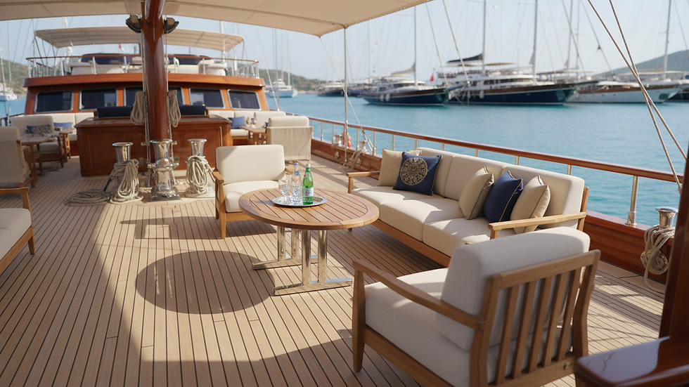 Close-up view of a luxury gulet's polished wooden deck and elegant seating area