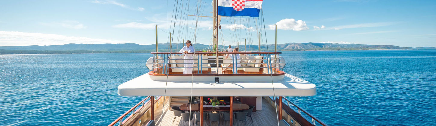 Alfresco dining setup on the aft deck of Son de Mar for evening meals