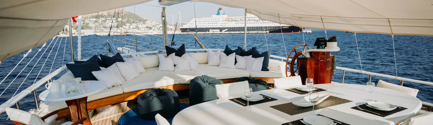 Beyaz Lale gulet aft deck shaded dining table on teak deck