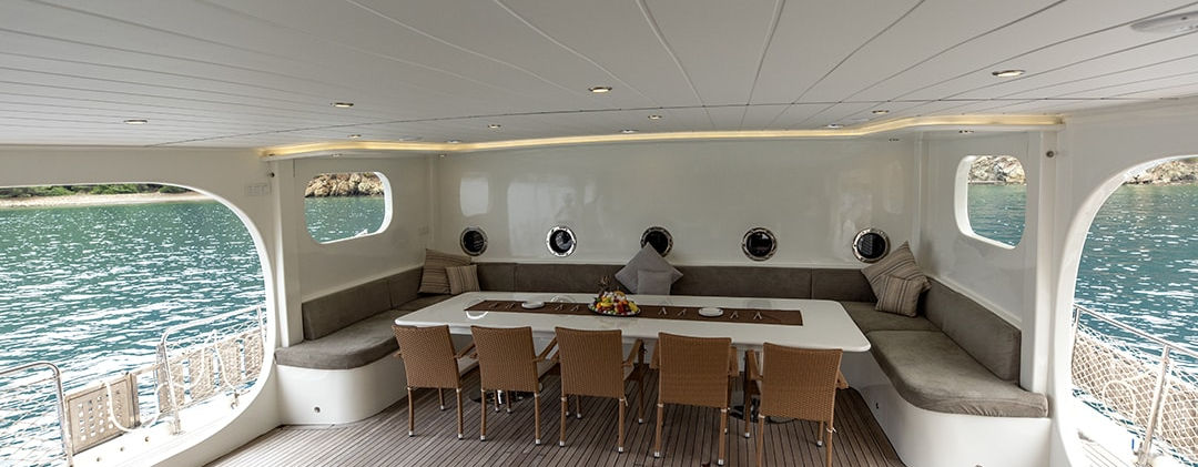 Kayhan 11 gulet aft deck dining area on teak deck under shade