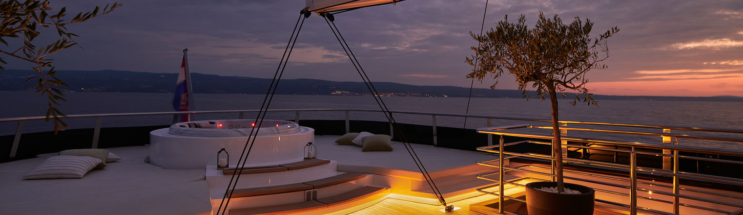 Anima Maris gulet flybridge jacuzzi and sun‑loungers under open sky