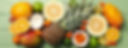 Set of tropical fruit on green wooden background, top view_edited.jpg
