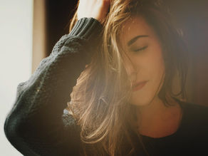 A woman holds her head with anxiety.