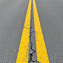 asphalt road with two yellow lines.jpg