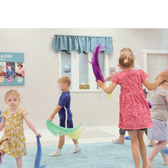 Young children moving with scarves in a Kindermusik class at Tuneful Journey.