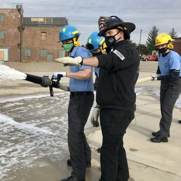 Blue Valley student working with a firefighter instructor