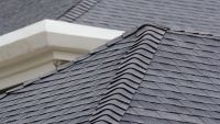 Close-up of gray asphalt shingles on a roof
