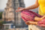 woman meditating in front of temple