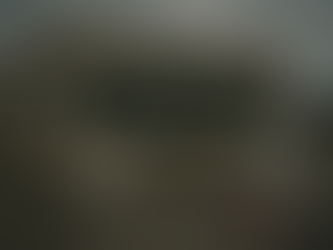 A run down Truelieve dispensary location with an empty parking lot and a now hiring sign falling outside