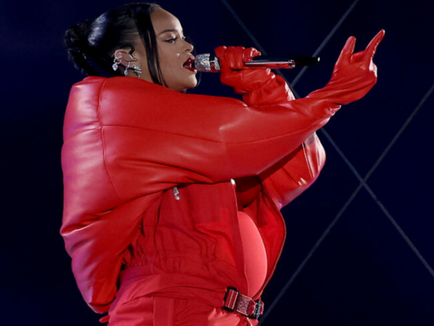 Rihanna reveals pregnancy as she performs off bump at Super bowl classic