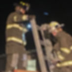 Marshall (left) performing ladder drills and ventilation training alongside other CVFD firefighters.