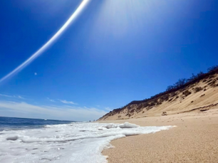 "Sweeping sandy dunes and Atlantic Ocean shoreline at a Wellfleet beach on Cape Cod"