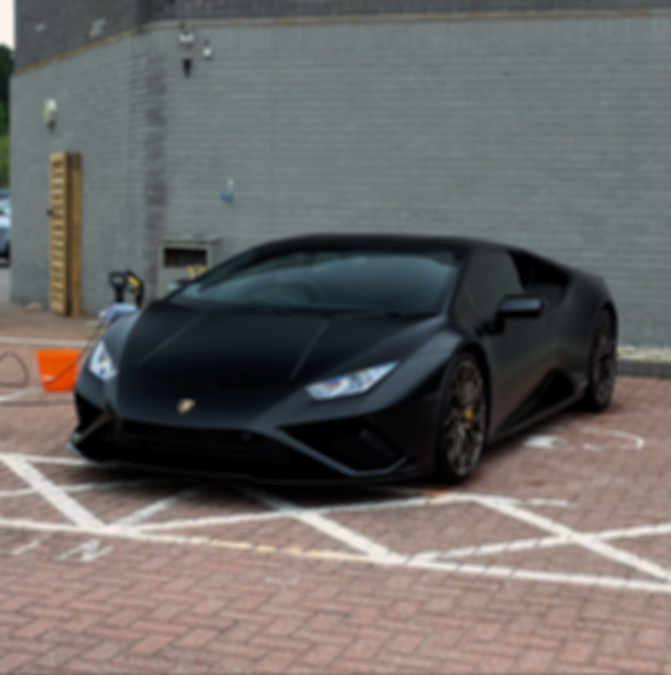 Black Lamborghini parked on brick pavers with detail equipment. Naples mobile car detailing.