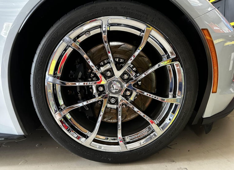 Chrome rims on silver sports car