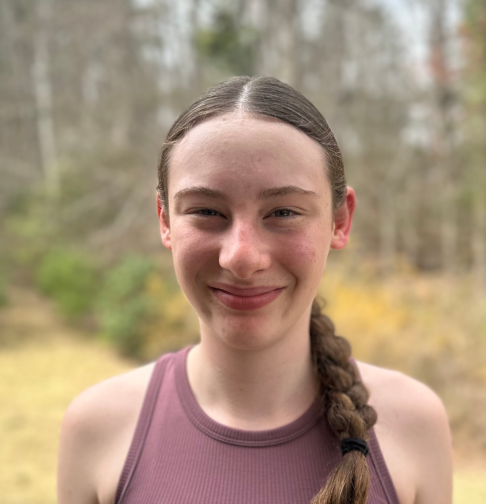 Smiling girl with braided hair standing outdoors