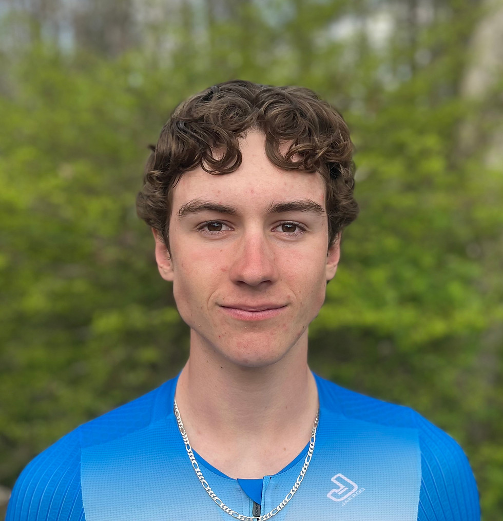 Young male cyclist in a blue Shredders jersey outdoors