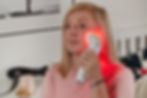 Photizo Blush Red Light Therapy Unit being used on face