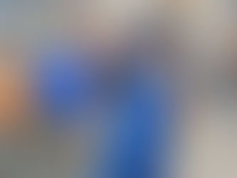 Boy wearing a blue superhero mask and cape striking a superhero pose at a kids birthday party in New Jersey