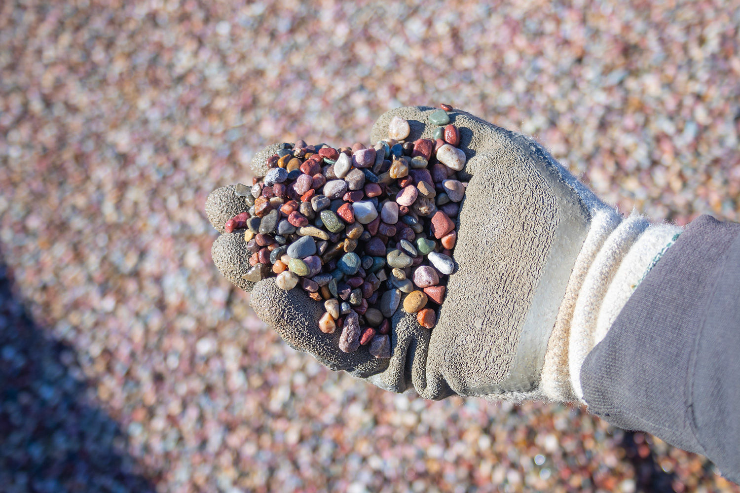 A handful of Rainbow Rock Pea Gravel (Round) - 3/8" Clean